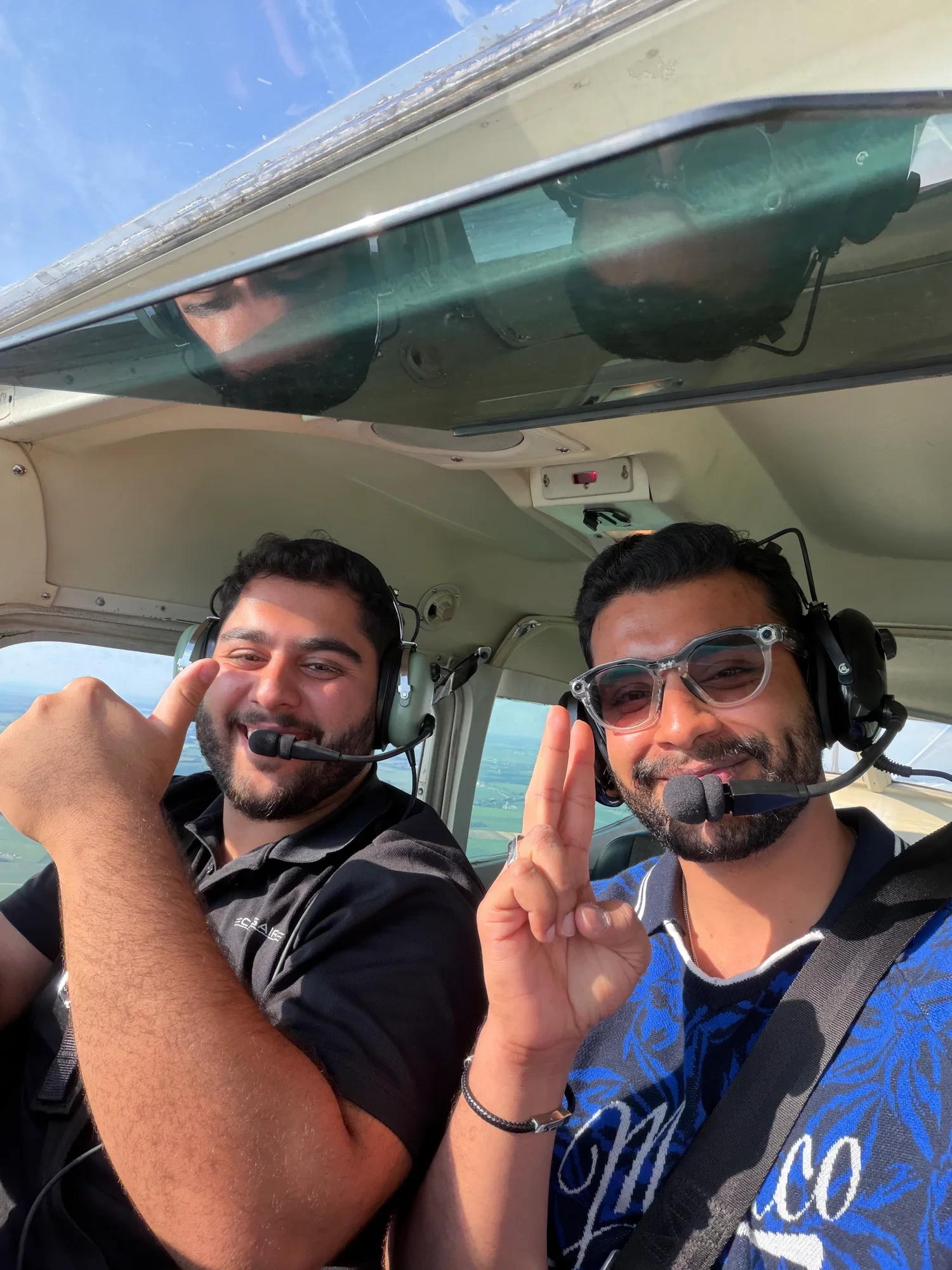 Adeel and a fellow flyer in an aircraft cockpit