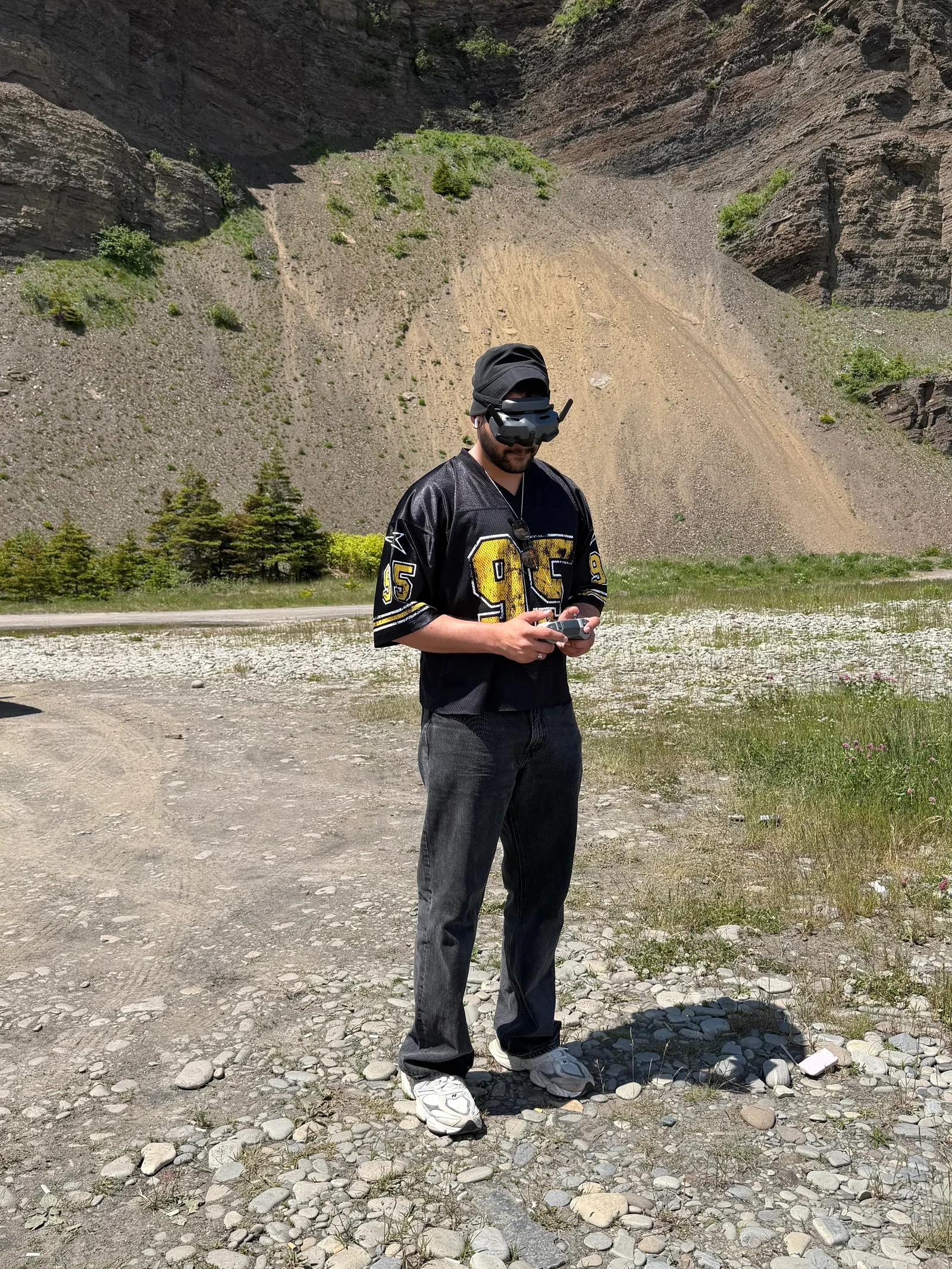 Adeel flying with FPV goggles and a controller